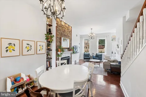 a living room with fireplace furniture and a chandelier