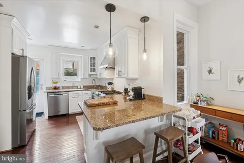 a kitchen with a sink stove and refrigerator