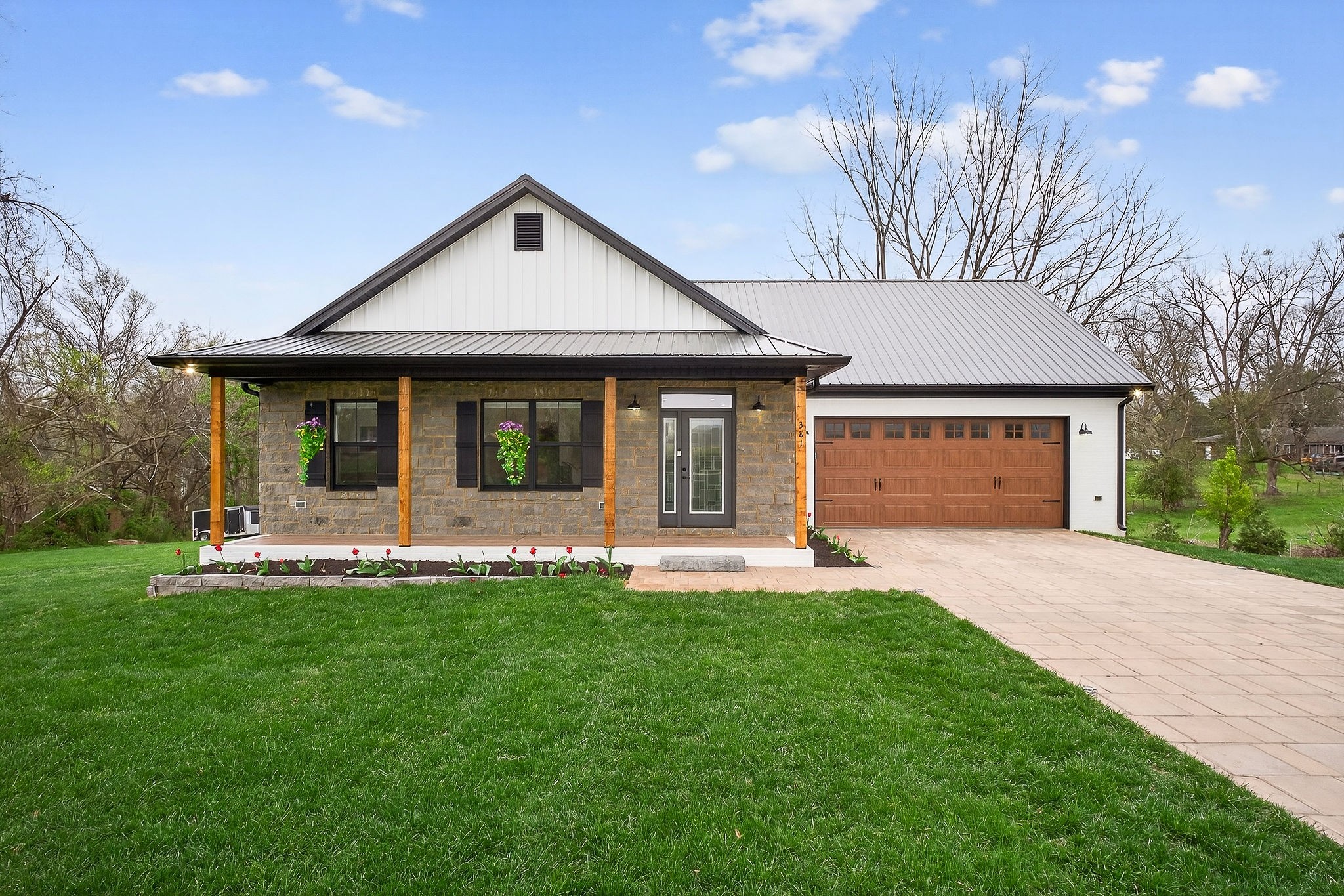a front view of a house with a yard and porch