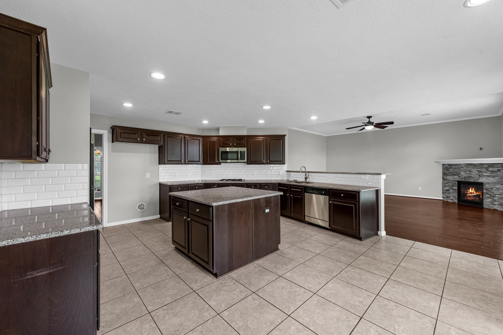 6606 Granbury Road Manvel, TX 77578 - Photo 17 of 48 Another view of the kitchen showing the seamless access to the living room.