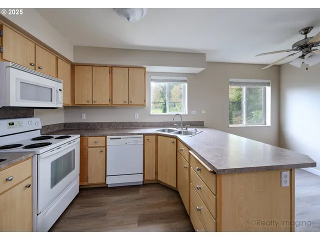 a kitchen with stainless steel appliances granite countertop a sink stove and cabinets