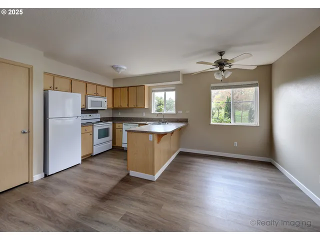 a kitchen with stainless steel appliances granite countertop a stove a sink dishwasher and a refrigerator