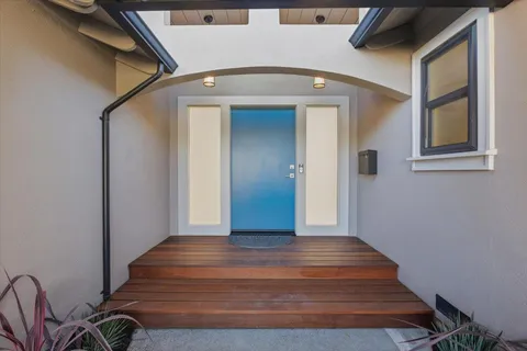 a living room with fireplace furniture and a large window