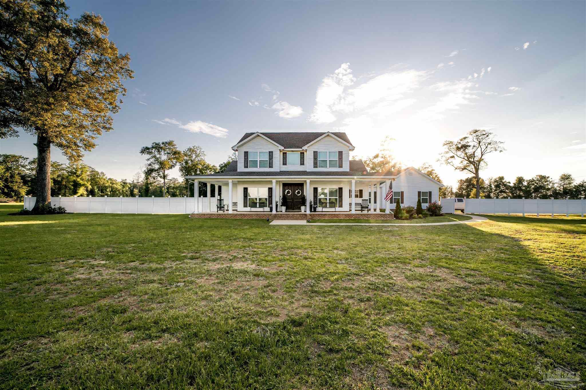 8165 Chumuckla Highway Pace, FL 32571 - Photo 1 of 50 a front view of a house with a swimming pool