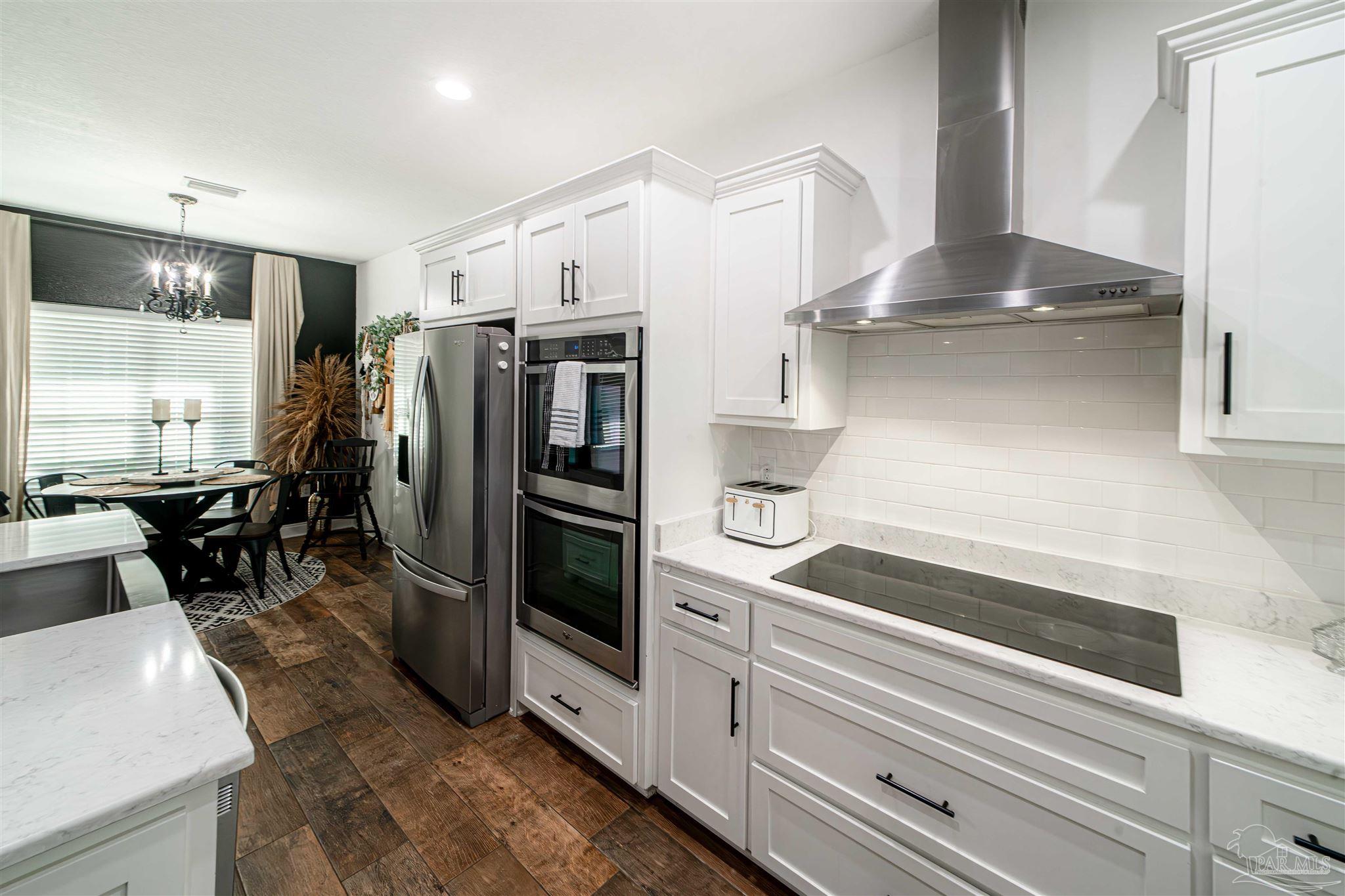 8165 Chumuckla Highway Pace, FL 32571 - Photo 16 of 50 a kitchen with stainless steel appliances granite countertop a refrigerator and a stove