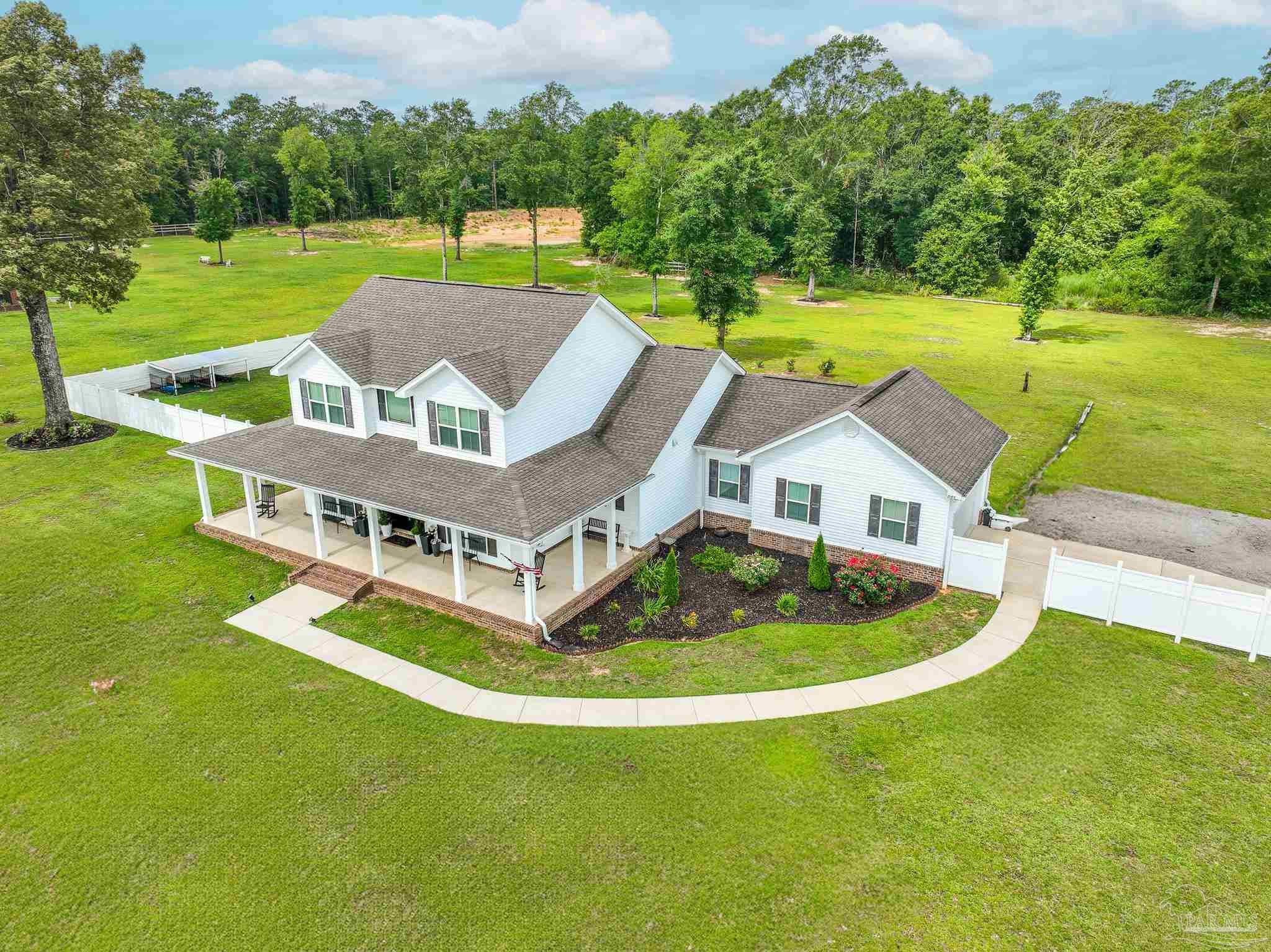 8165 Chumuckla Highway Pace, FL 32571 - Photo 2 of 50 an aerial view of a house with swimming pool garden and outdoor seating