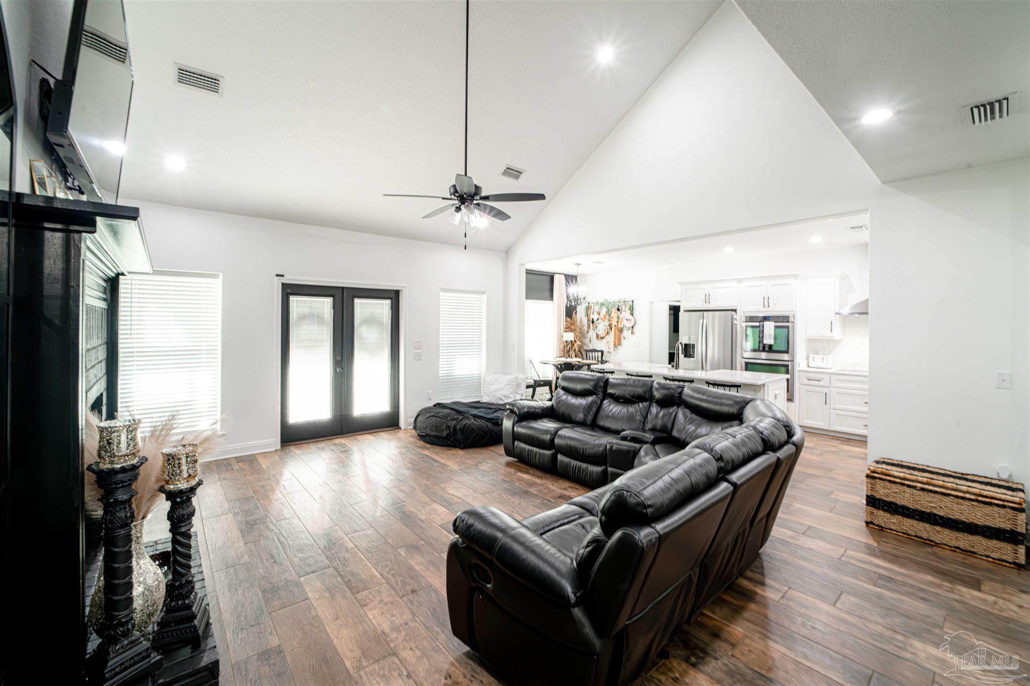 8165 Chumuckla Highway Pace, FL 32571 - Photo 21 of 50 a living room with furniture and a flat screen tv