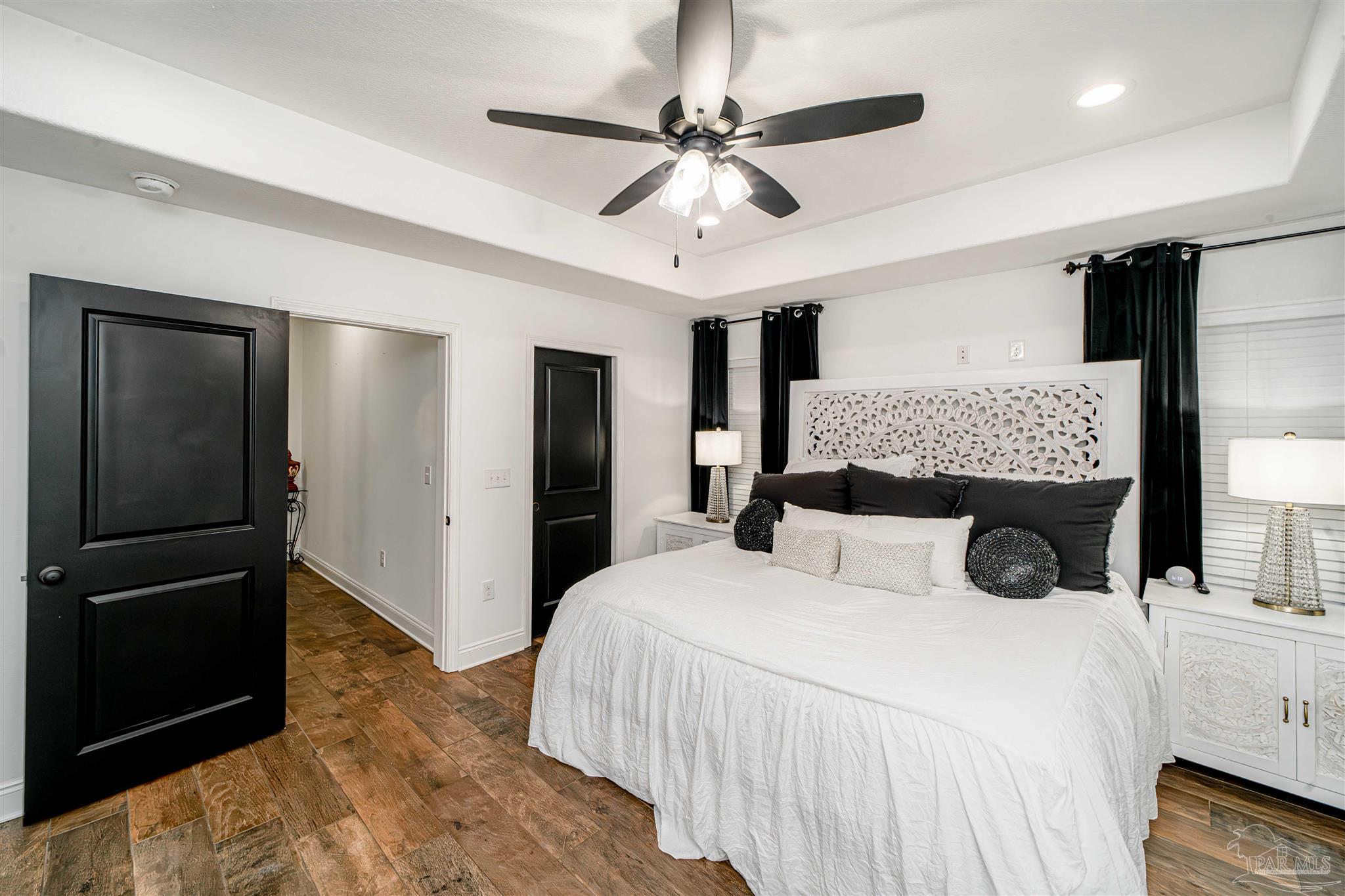 8165 Chumuckla Highway Pace, FL 32571 - Photo 22 of 50 a bedroom with a bed and a walk in closet