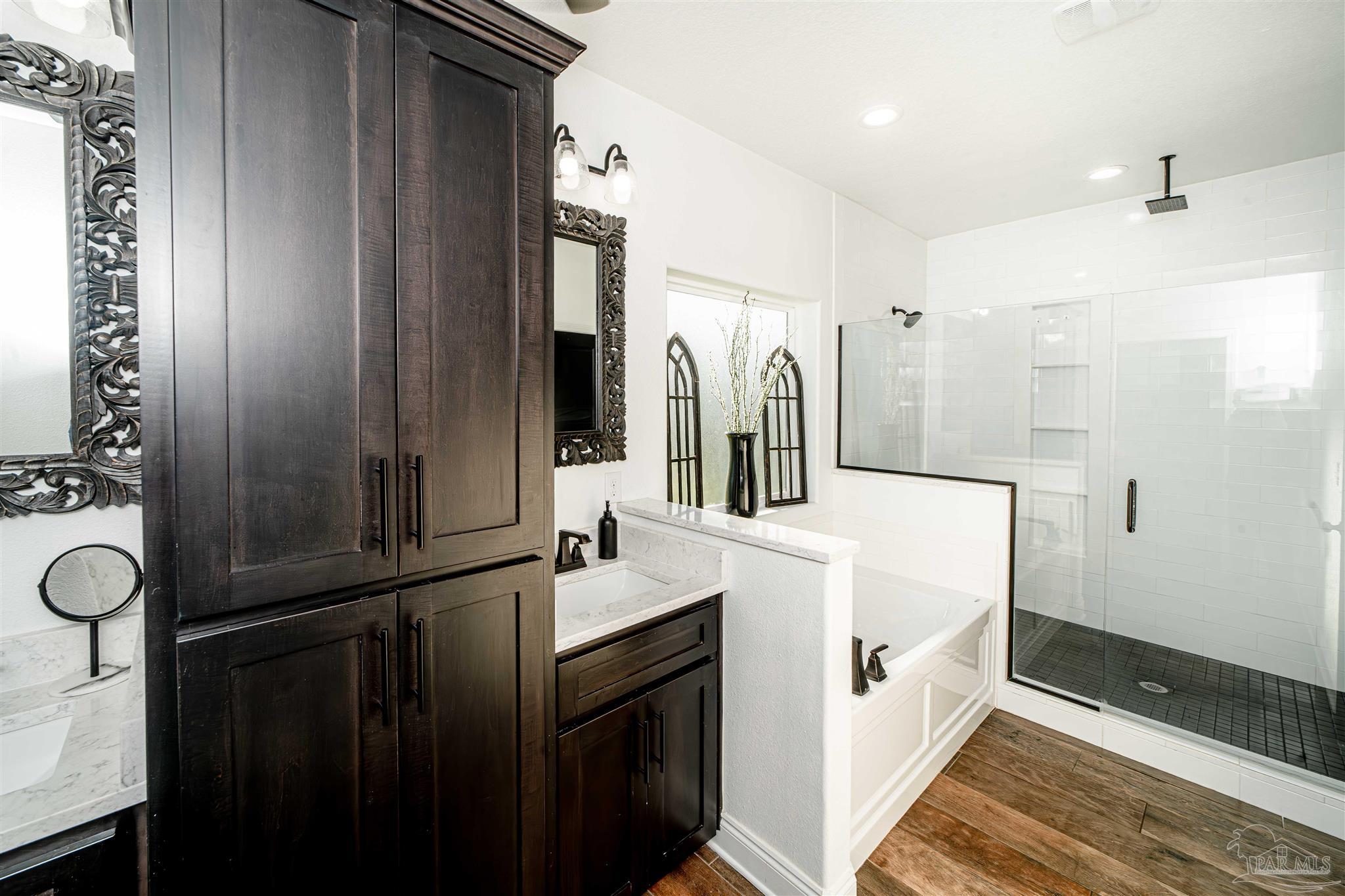 8165 Chumuckla Highway Pace, FL 32571 - Photo 27 of 50 a bathroom with a double vanity sink and mirror