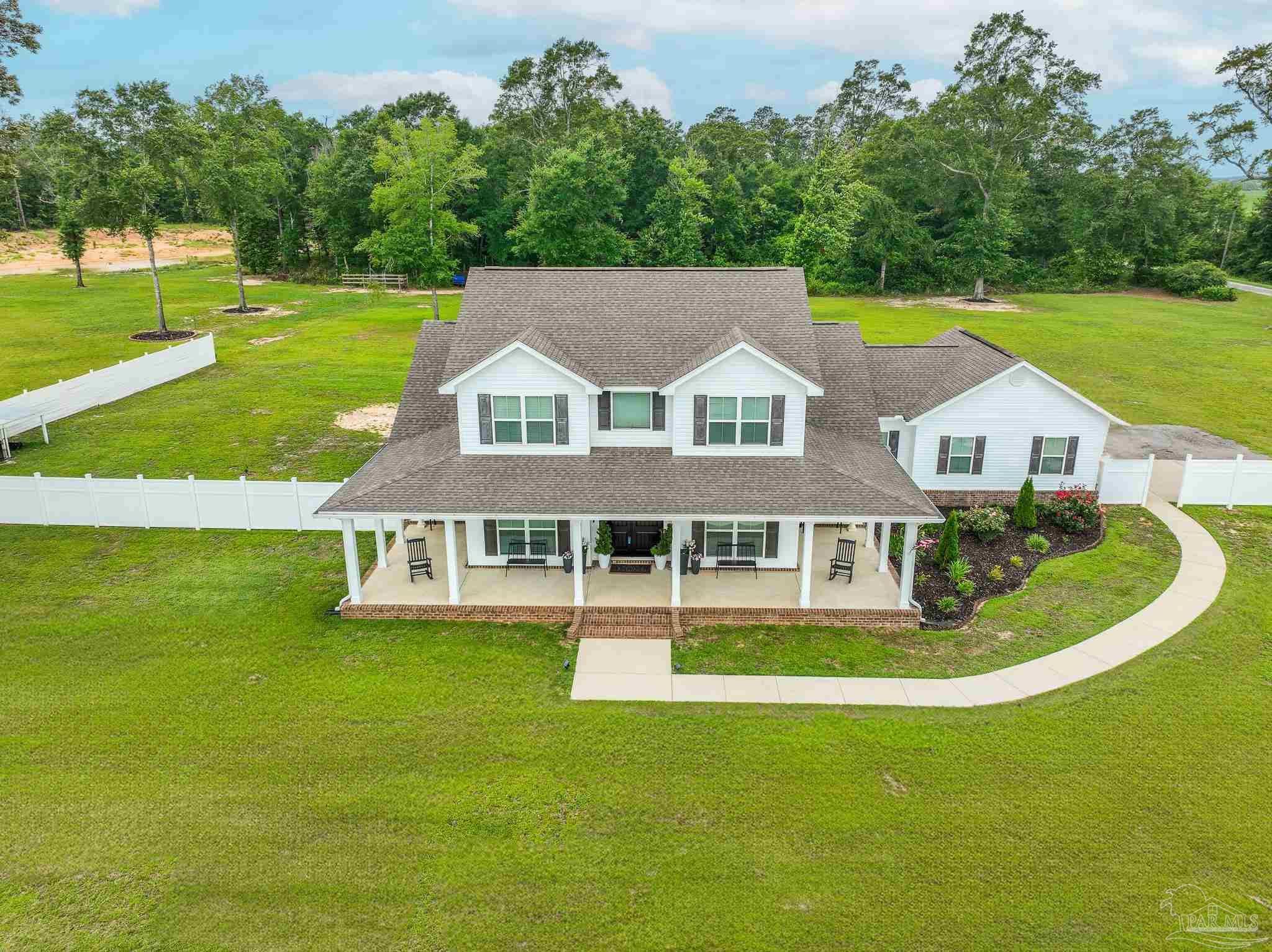 8165 Chumuckla Highway Pace, FL 32571 - Photo 3 of 50 a aerial view of a house with swimming pool having outdoor seating