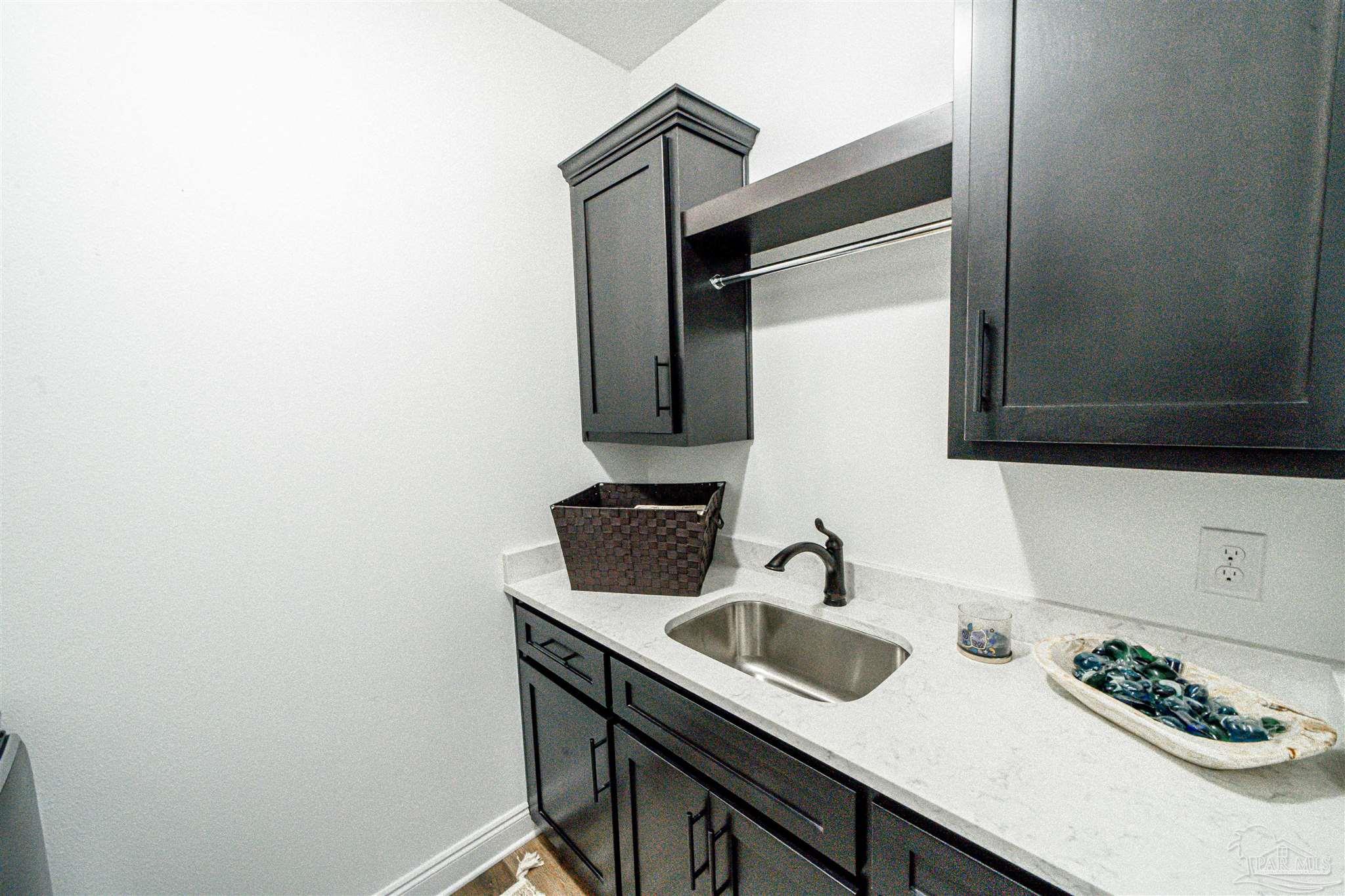 8165 Chumuckla Highway Pace, FL 32571 - Photo 31 of 50 a bathroom with a sink and a mirror