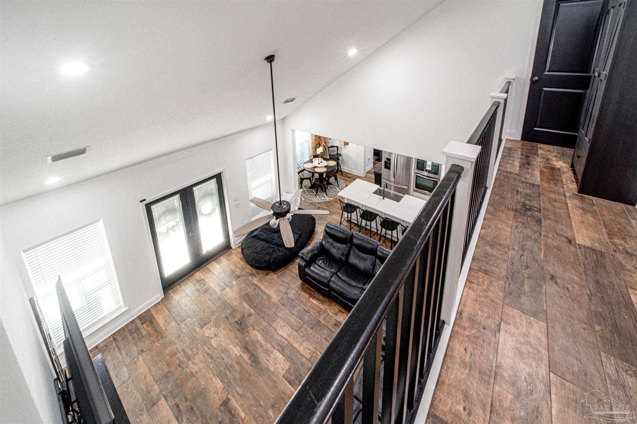 8165 Chumuckla Highway Pace, FL 32571 - Photo 34 of 50 a living room with chairs and a wooden floor