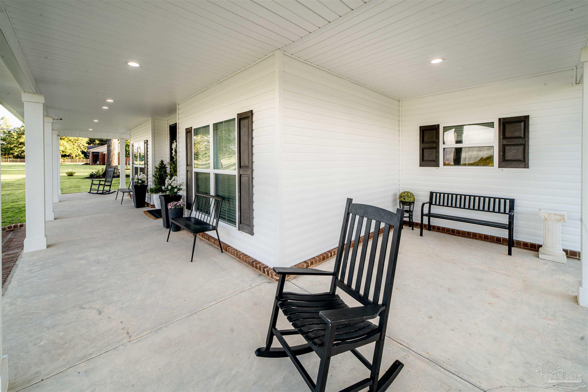 8165 Chumuckla Highway Pace, FL 32571 - Photo 37 of 50 a view of a livingroom with furniture and floor to ceiling window