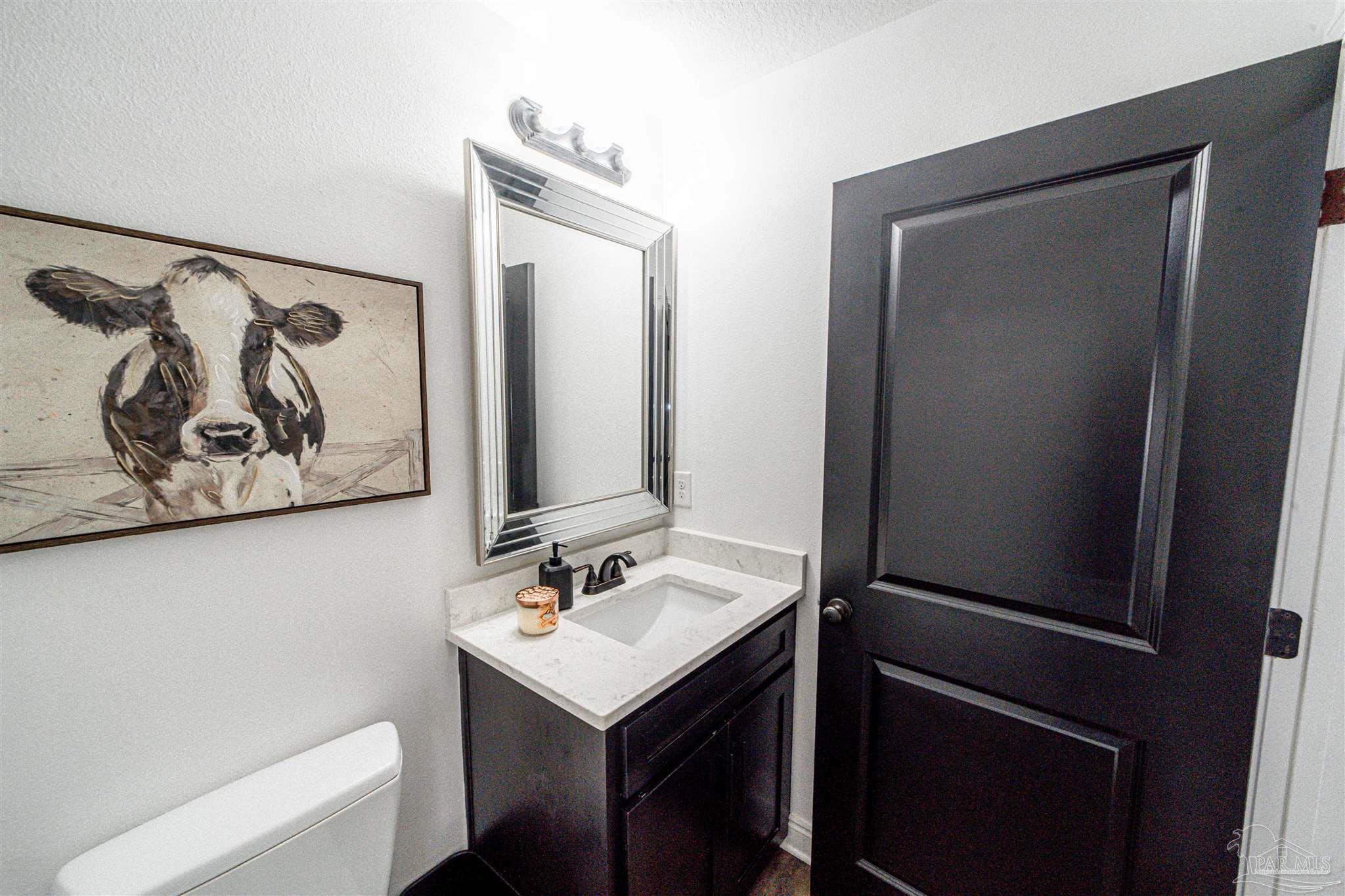 8165 Chumuckla Highway Pace, FL 32571 - Photo 39 of 50 a bathroom with a sink and a mirror