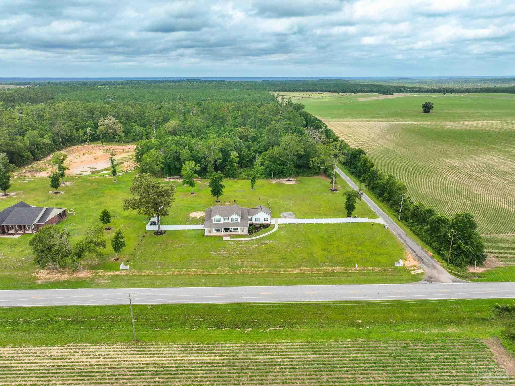 8165 Chumuckla Highway Pace, FL 32571 - Photo 4 of 50 a view of a swimming pool with a yard