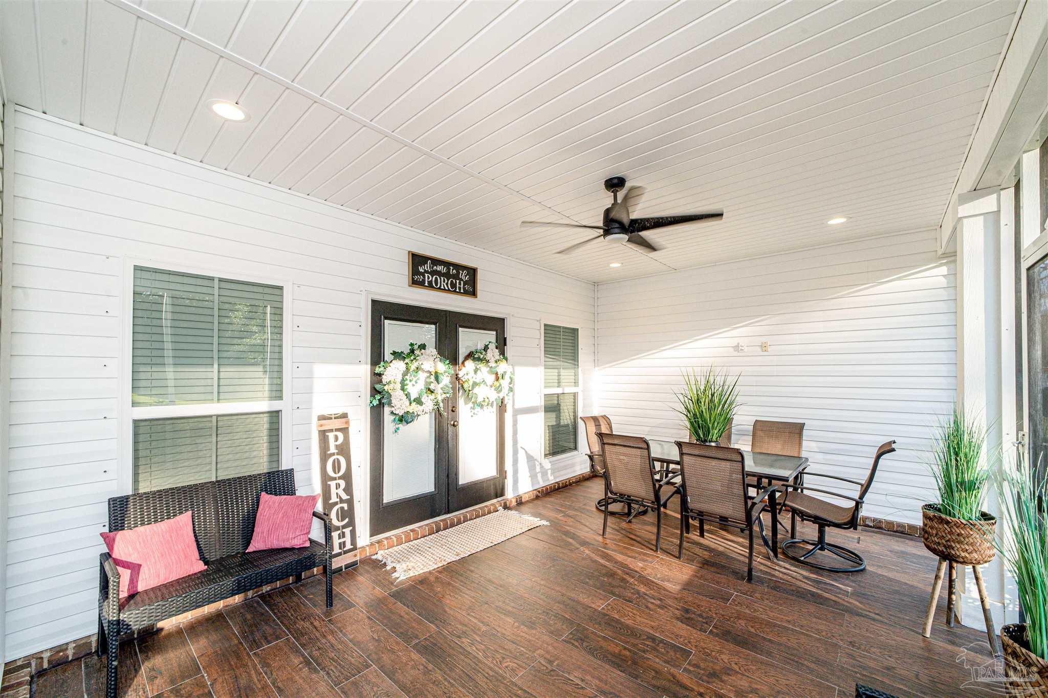8165 Chumuckla Highway Pace, FL 32571 - Photo 43 of 50 a workspace with furniture wooden floor and windows
