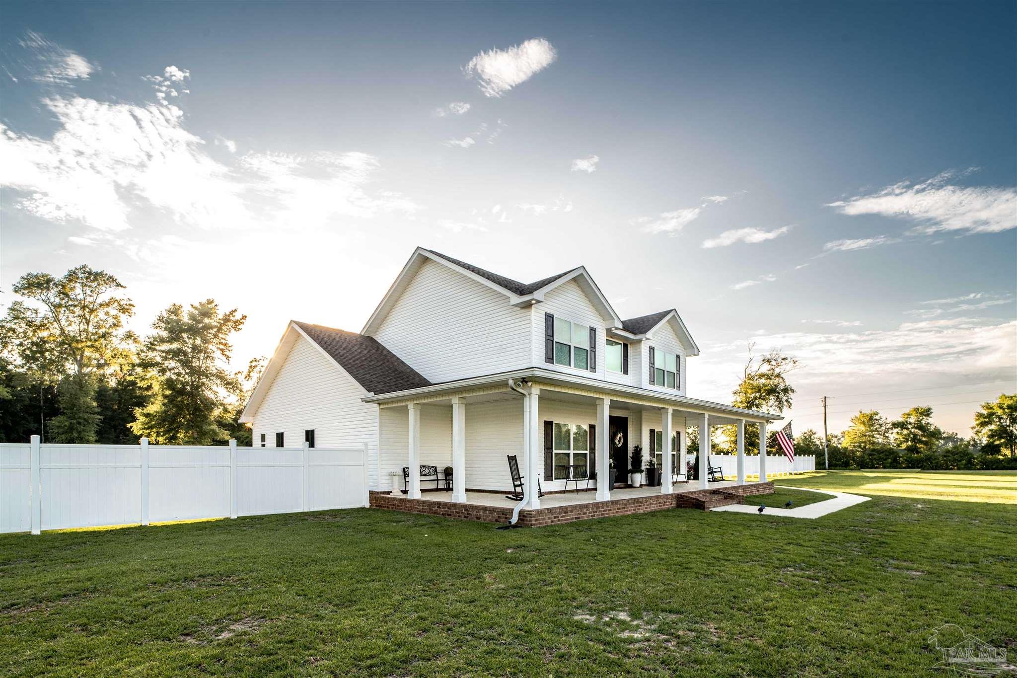 8165 Chumuckla Highway Pace, FL 32571 - Photo 46 of 50 a view of a white house with a big yard and large trees