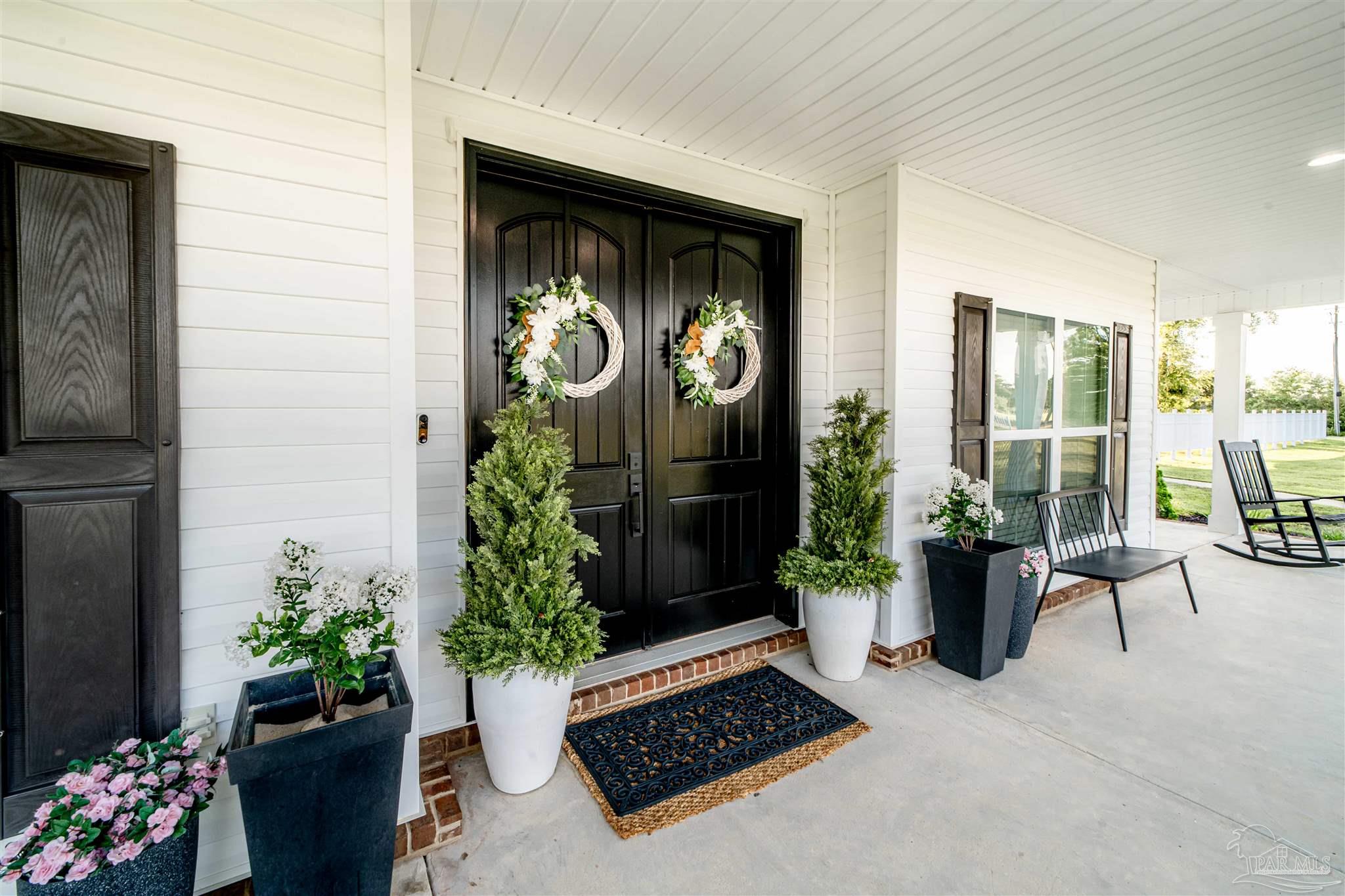 8165 Chumuckla Highway Pace, FL 32571 - Photo 7 of 50 a view of a entryway door of the house