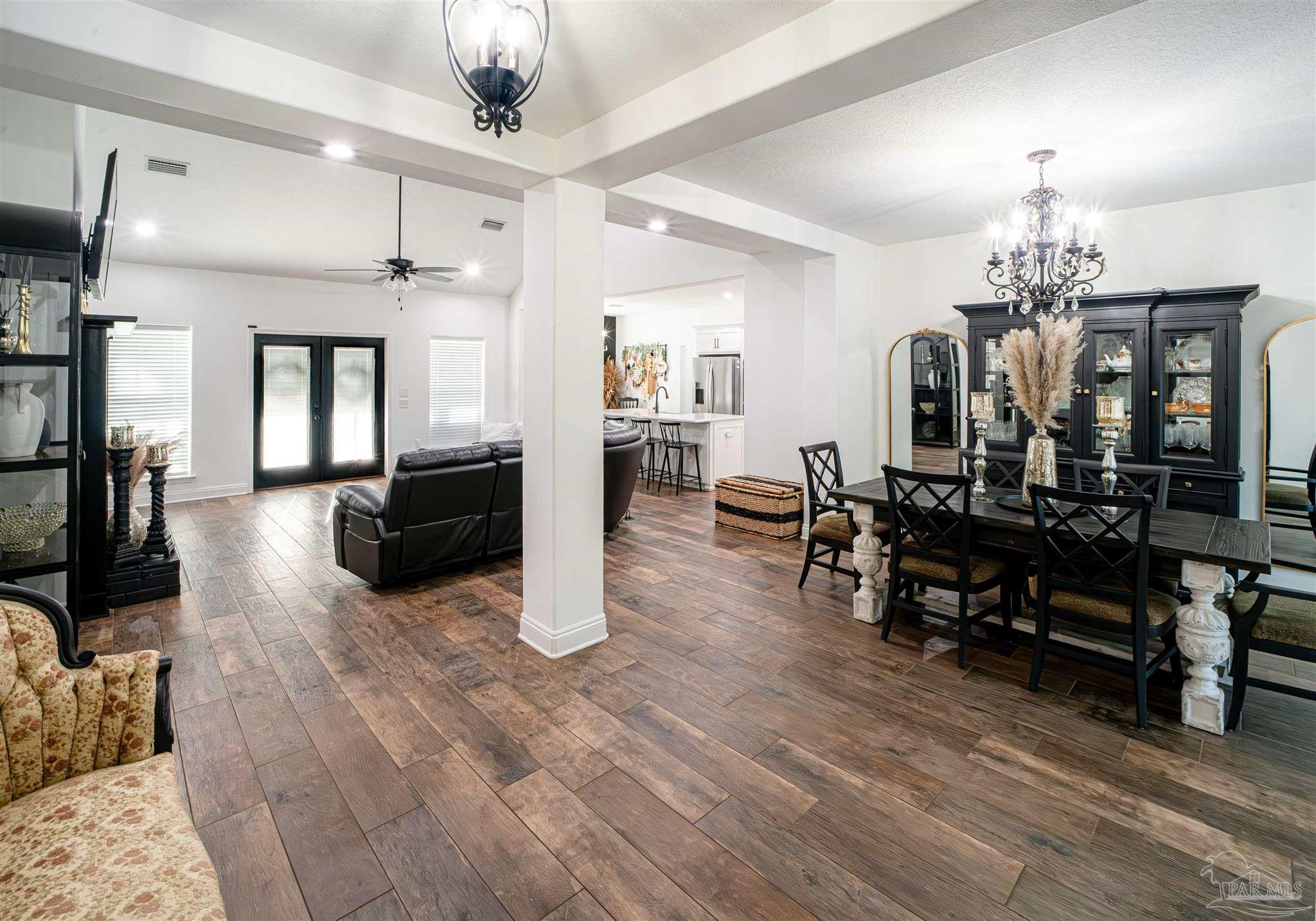8165 Chumuckla Highway Pace, FL 32571 - Photo 8 of 50 a living room with furniture and wooden floor