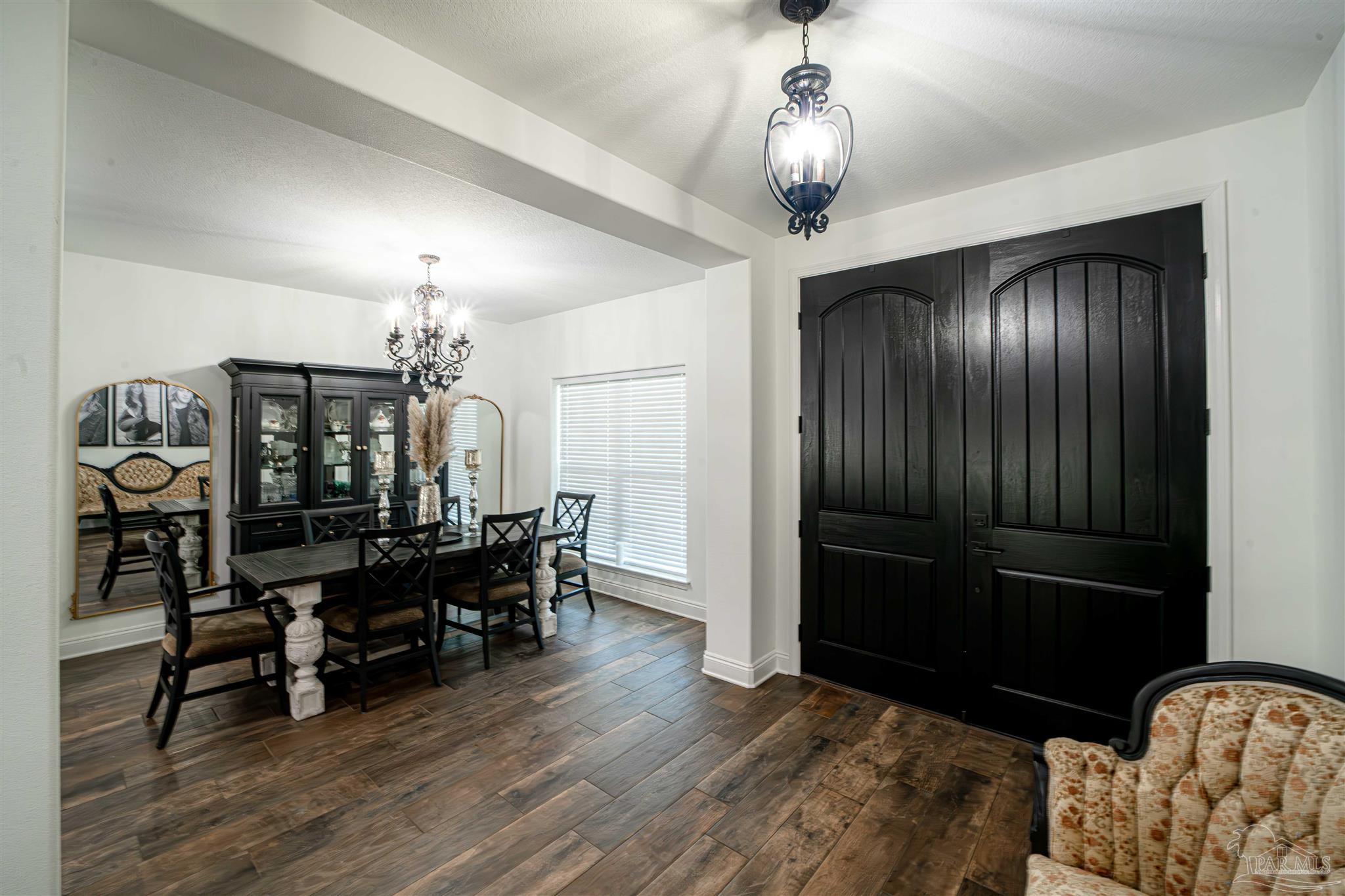 8165 Chumuckla Highway Pace, FL 32571 - Photo 10 of 50 a view of a livingroom with furniture and chandelier
