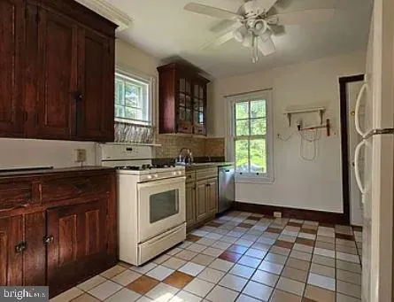 a kitchen with a stove a sink and a cabinets