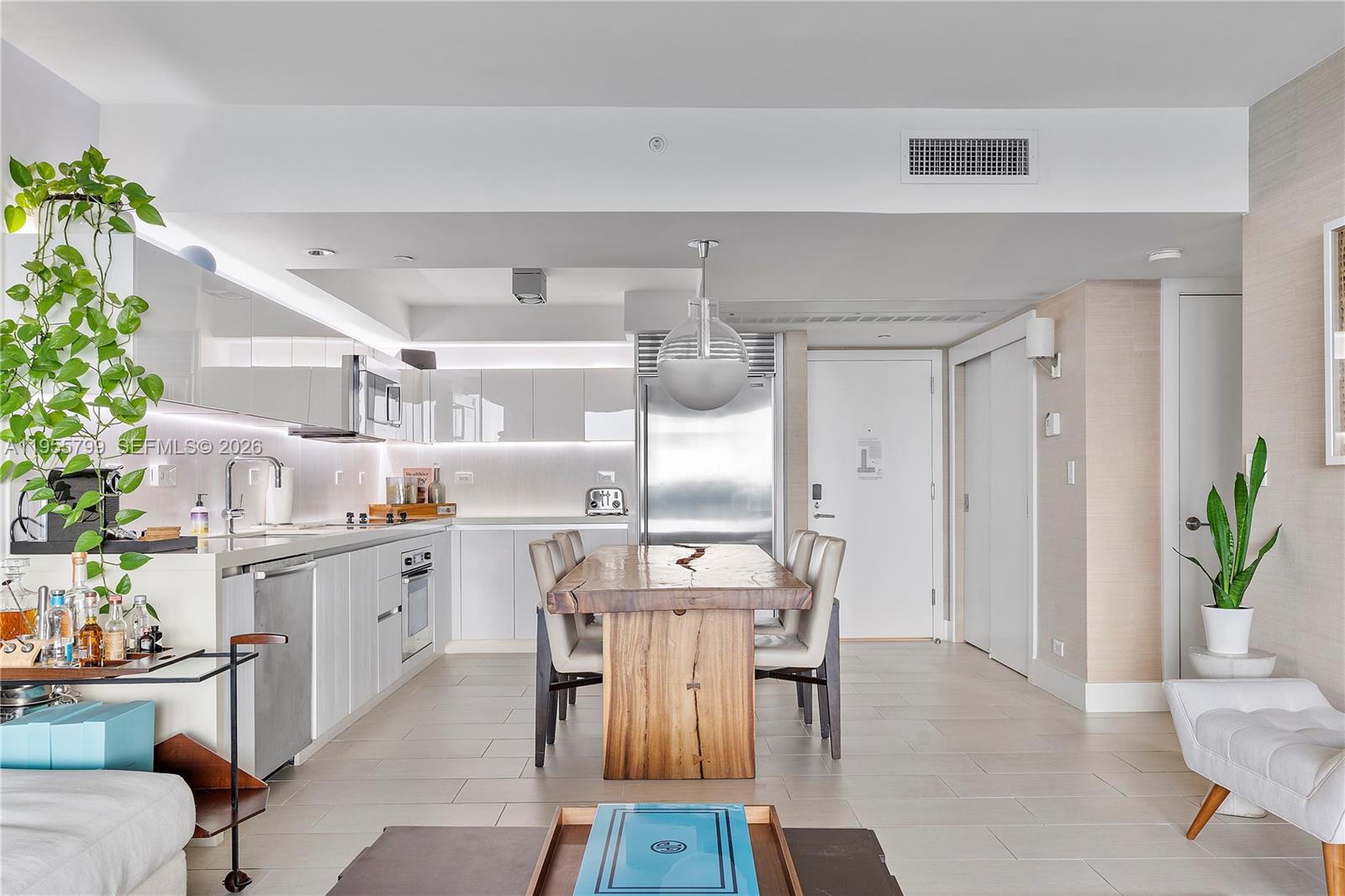 102 24th Street, Unit 1427 Miami Beach, FL 33139 - Photo 11 of 77 a view of a dining room with furniture window and wooden floor