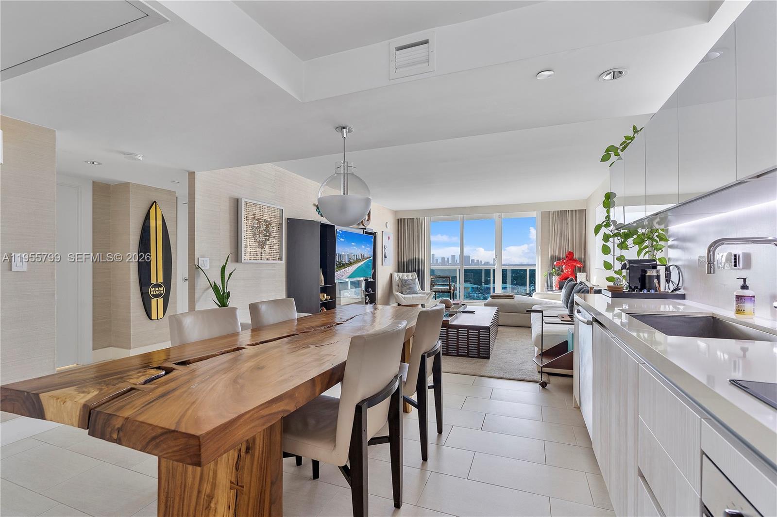 102 24th Street, Unit 1427 Miami Beach, FL 33139 - Photo 17 of 77 a large kitchen with a counter space a sink appliances and living room view