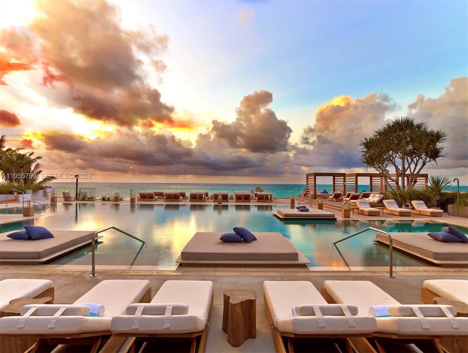 102 24th Street, Unit 1427 Miami Beach, FL 33139 - Photo 55 of 77 a view of a lake with lawn chairs