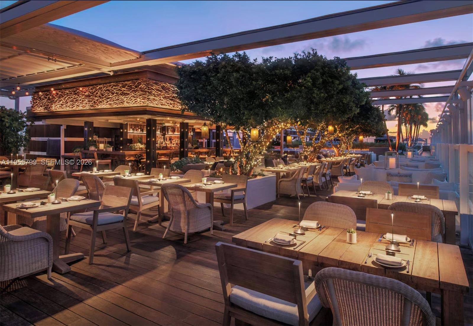 102 24th Street, Unit 1427 Miami Beach, FL 33139 - Photo 74 of 77 a view of a chairs and table in patio with a barbeque
