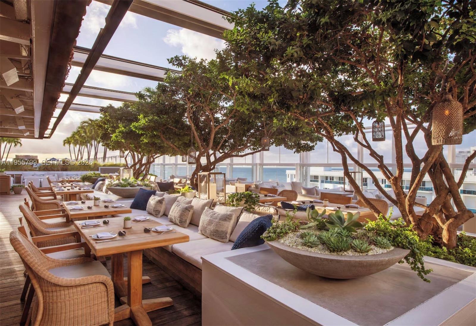 102 24th Street, Unit 1427 Miami Beach, FL 33139 - Photo 76 of 77 a view of a terrace with furniture and potted plants