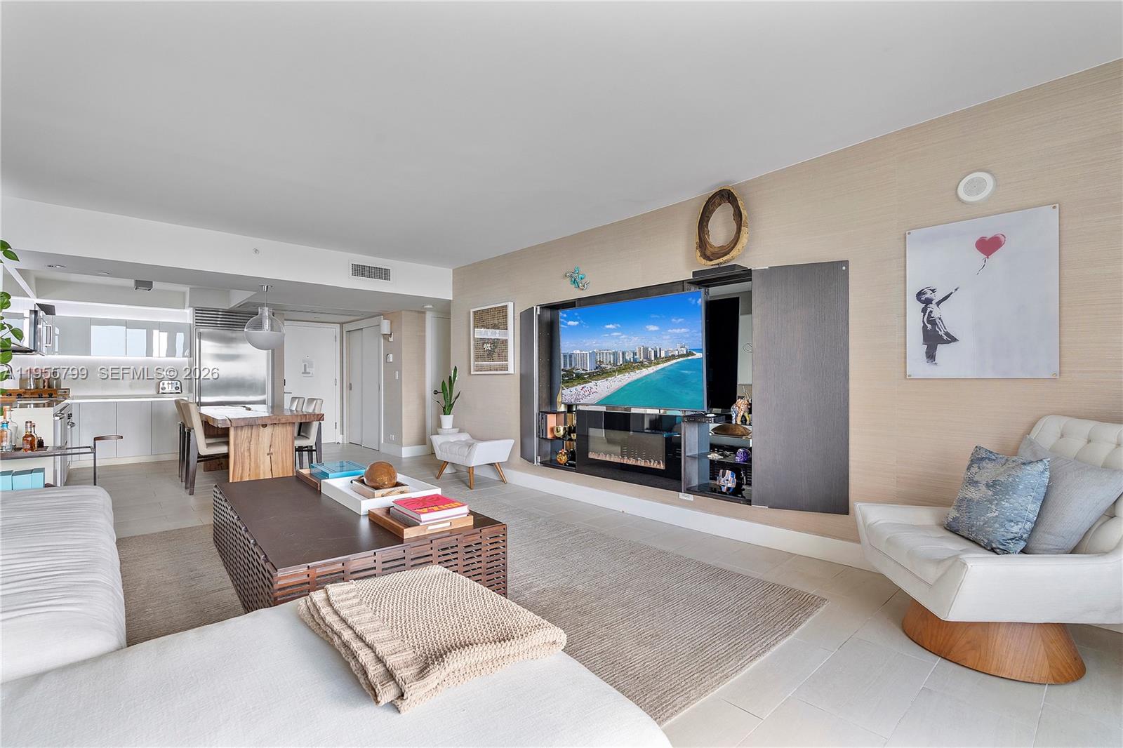 102 24th Street, Unit 1427 Miami Beach, FL 33139 - Photo 9 of 77 a living room with furniture and a flat screen tv