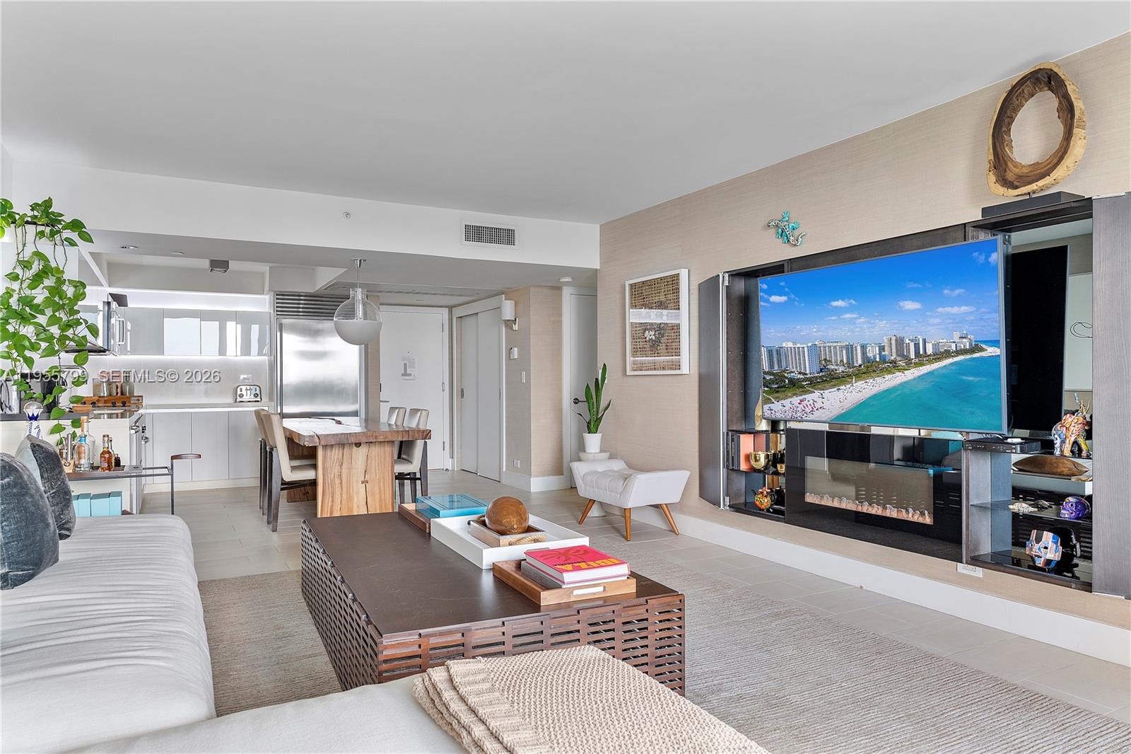 102 24th Street, Unit 1427 Miami Beach, FL 33139 - Photo 10 of 77 a living room with furniture and a flat screen tv