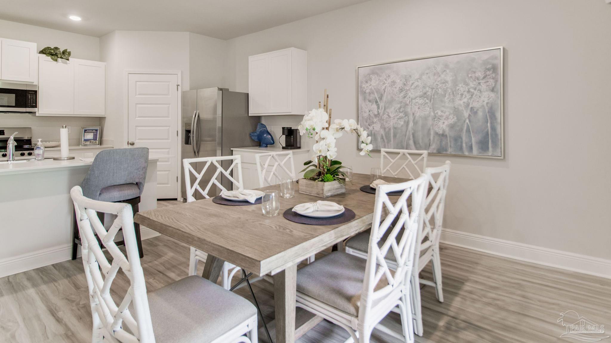 4773 Redhead Court Pace, FL 32571 - Photo 12 of 37 a view of a dining room with furniture and wooden floor