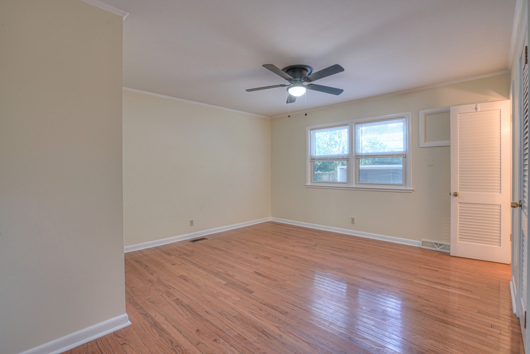 1827 Middle Tennessee Boulevard Murfreesboro, TN 37130 - Photo 11 of 21 an empty room with wooden floor fan and windows