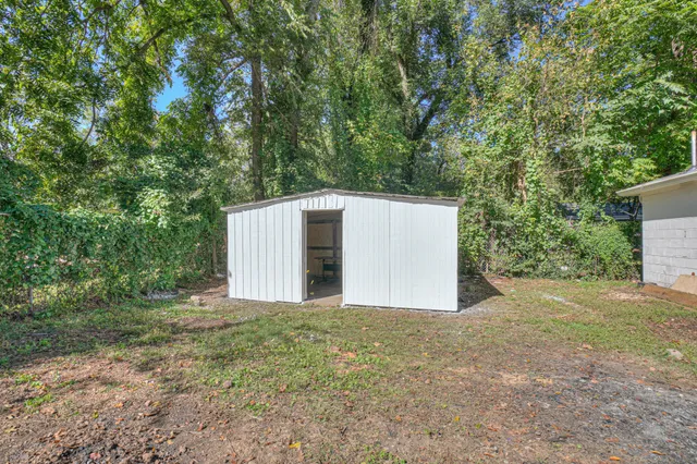 a view of a barn in the middle of a yard