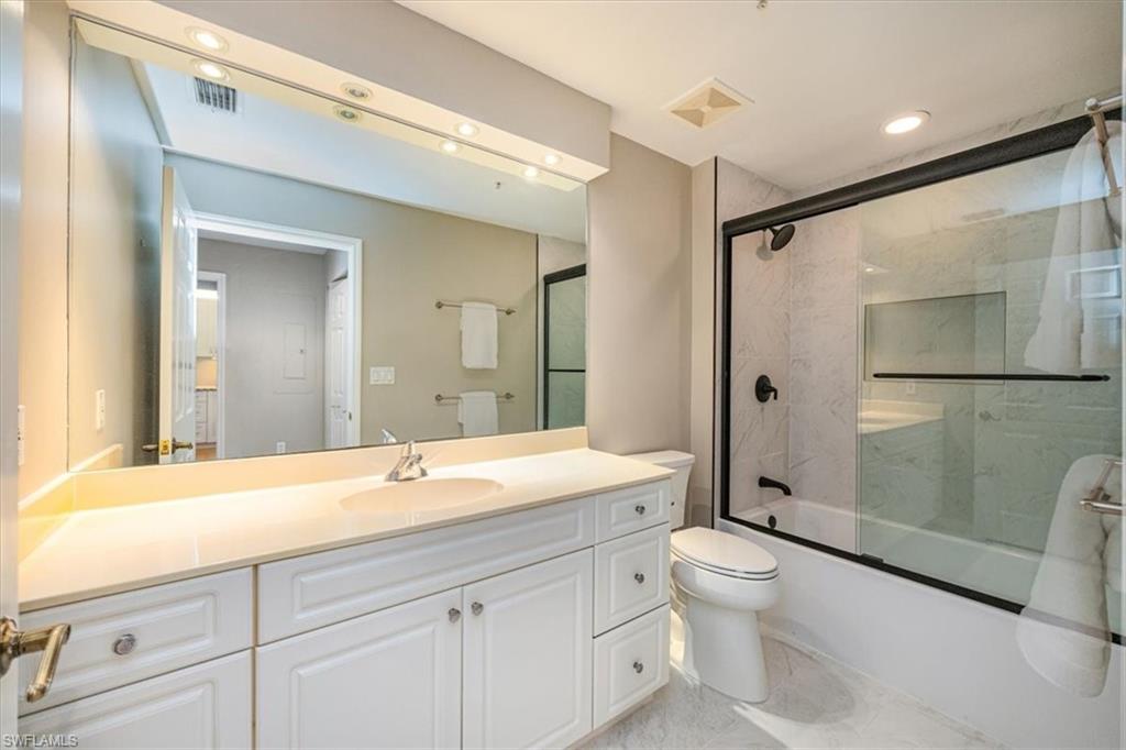 401 Bayfront Place, Unit 3404 Naples, FL 34102 - Photo 11 of 14 a spacious bathroom with a shower sink mirror and toilet