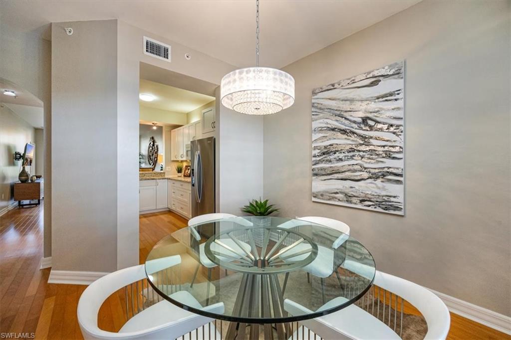 401 Bayfront Place, Unit 3404 Naples, FL 34102 - Photo 5 of 14 a view of a dining room with furniture and wooden floor