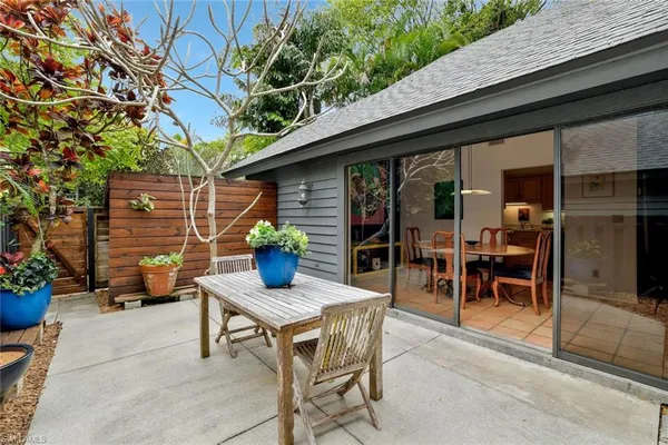 a backyard of a house with table and chairs