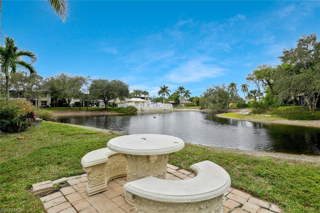 1329 Solana Road, Unit K5 Naples, FL 34103 - Photo 16 of 20 a view of a lake with a table and chairs