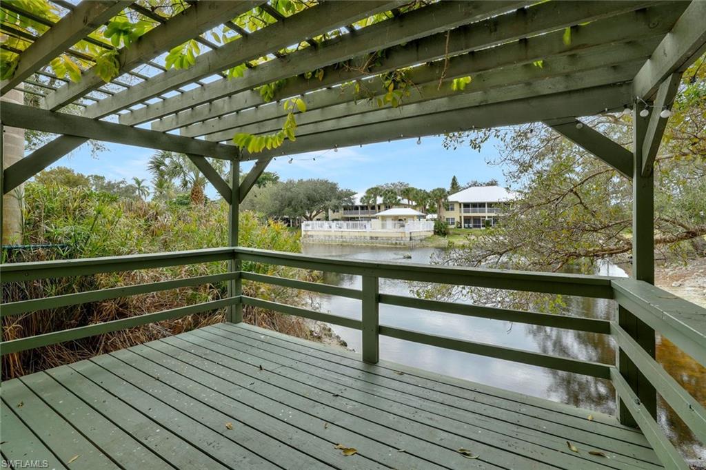 1329 Solana Road, Unit K5 Naples, FL 34103 - Photo 18 of 20 a view of outdoor space with wooden floor and outdoor seating
