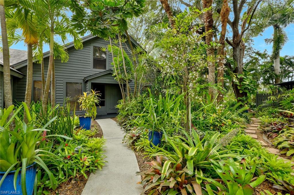1329 Solana Road, Unit K5 Naples, FL 34103 - Photo 2 of 20 a front view of a house with a yard