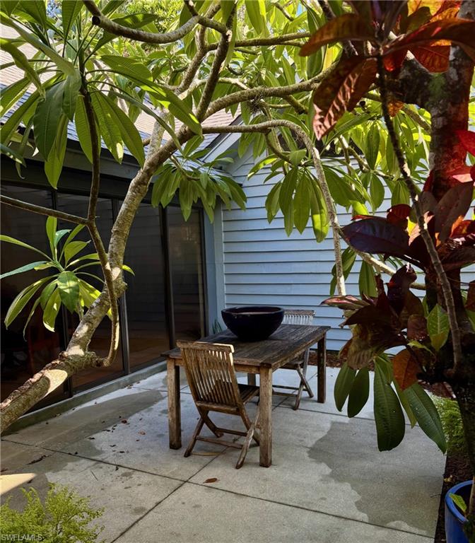 1329 Solana Road, Unit K5 Naples, FL 34103 - Photo 21 of 25 View of patio with the Fangipani is in bloom.