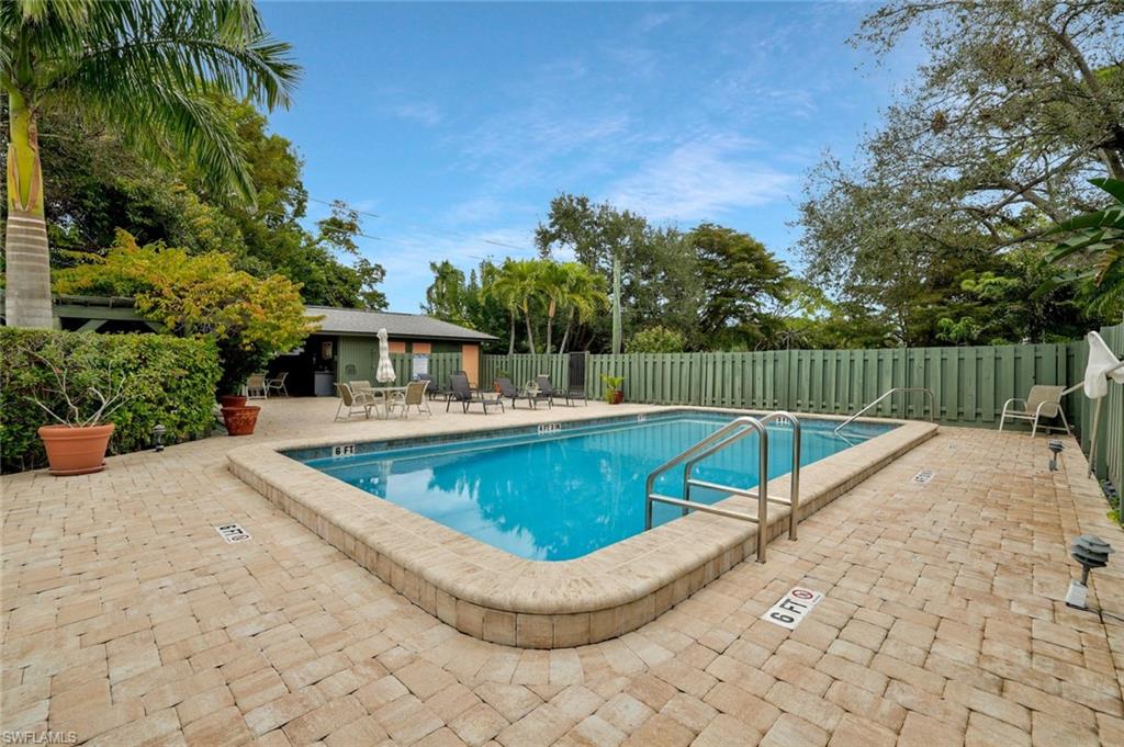 1329 Solana Road, Unit K5 Naples, FL 34103 - Photo 24 of 25 Pool area has a cabana to get out of the sun or get-togethers.