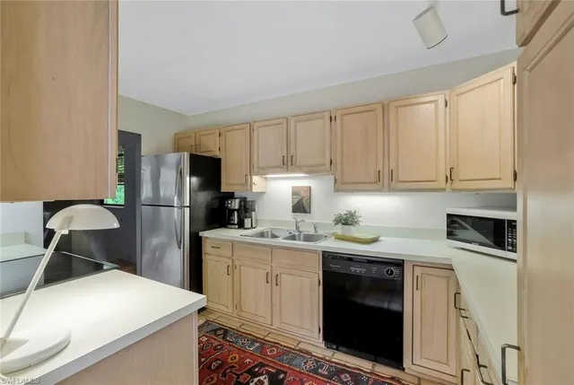 a kitchen with stainless steel appliances granite countertop a stove a refrigerator and a cabinets