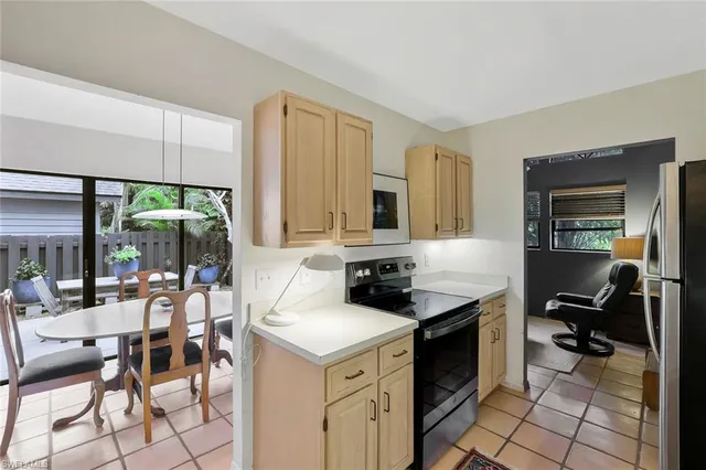 a kitchen with a stove a sink and a refrigerator