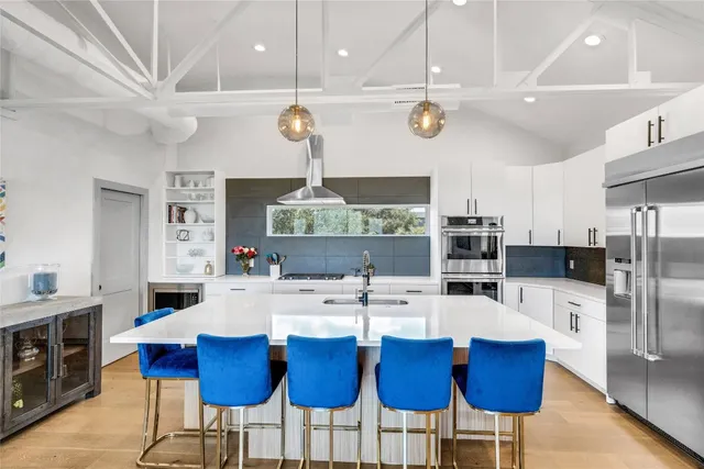 a large kitchen with a table and chairs