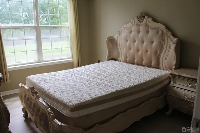 a bed sitting in a bedroom next to a window