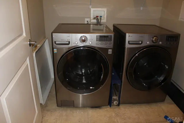 a view of a storage & utility room with dryer and washer