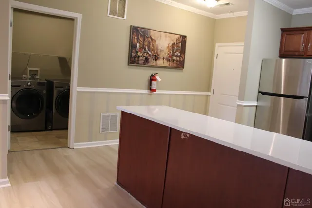 a kitchen with a refrigerator and a sink