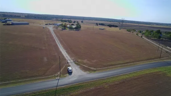 an aerial view of a house with a yard and lake view